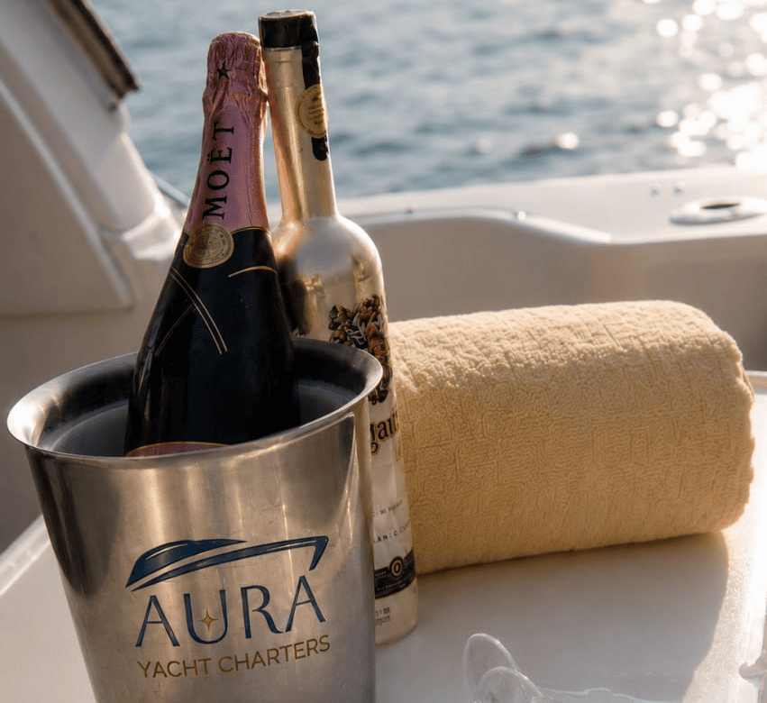 Moet champagne and a white wine on a bucket with the aura logo